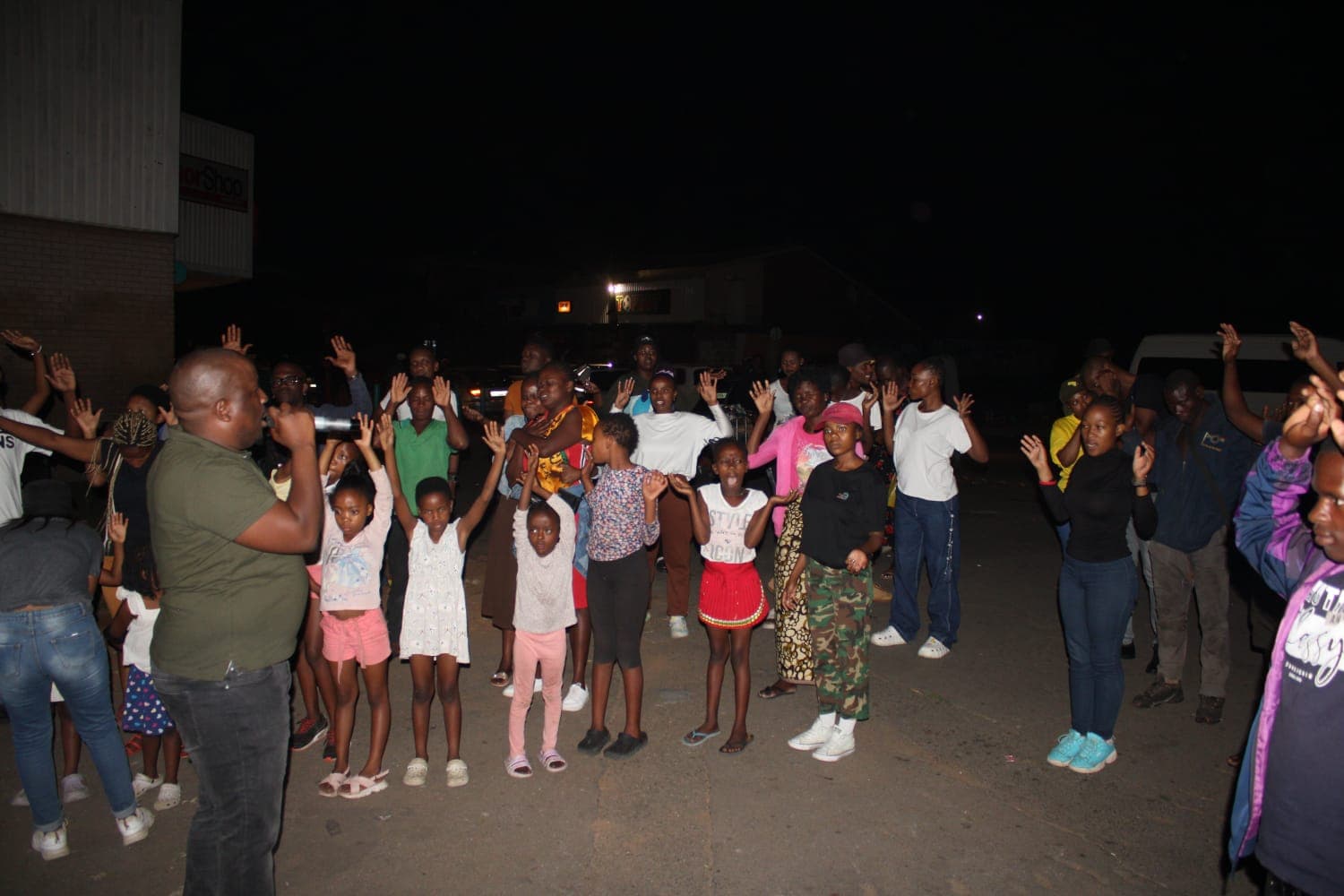 Open-air evangelism moment connected to Renewed Life ministry.