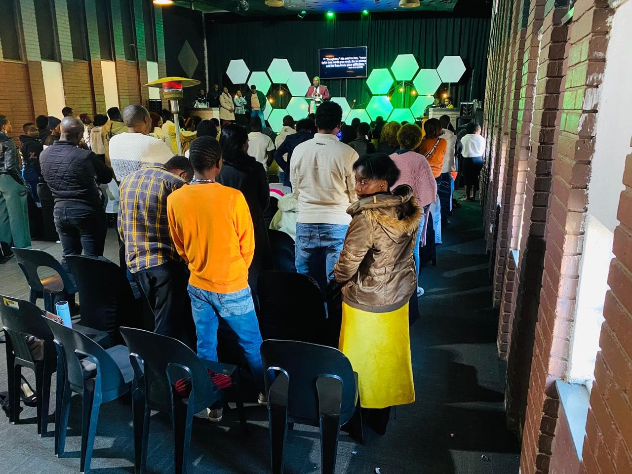 Congregation engaged in worship at Renewed Life International.